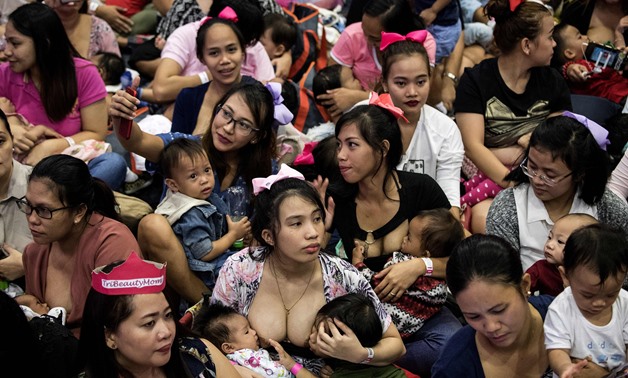 Mothers participate in a breastfeeding event in Manila on August 5, 2018. Hundreds of Philippine mothers simultaneously nursed their babies in public on Sunday, some of them two at a time, in a government-backed mass breastfeeding event aimed at combating