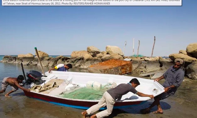 Local Baluch fishermen push a boat to the shore at a fishing port in Tiss village in the suburb of the port city of Chabahar 1,452 km (902 miles) southeast of Tehran, near Strait of Hormuz January 16, 2012 - Reuters