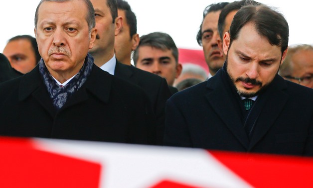 Turkish President Tayyip Erdogan, accompanied by Energy Minister Berat Albayrak, attends a funeral ceremony for police officer Hasim Usta who was killed in Saturday's blasts, in Istanbul, Turkey, December 12, 2016. REUTERS/Osman Orsal/File Photo