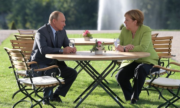 Merkel, Putin tackle tough topics in meeting outside Berlin - Reuters