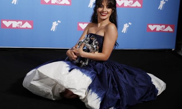 2018 MTV Video Music Awards - Photo Room - Radio City Music Hall, New York, U.S., August 20, 2018. - Camila Cabello poses backstage with her awards for Artist of the Year and Video of the Year for "Havana." REUTERS/Carlo Allegri.