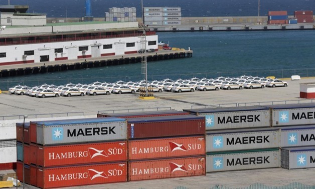 Shipping containers belonging to Hamburg Sud and Maersk companies are seen stacked at La Guaira port, in La Guaira, Venezuela, January 27, 2016. REUTERS/Marco Bello

