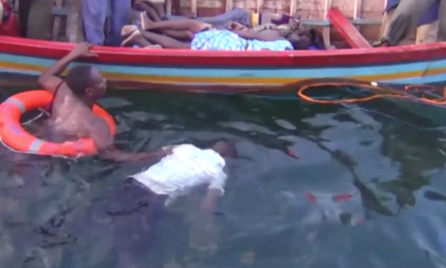 A rescue worker retrieves a body from the water after a ferry overturned in Lake Victoria, Tanzania September 21, 2018, in this still image taken from video. Reuters TV/via REUTERS