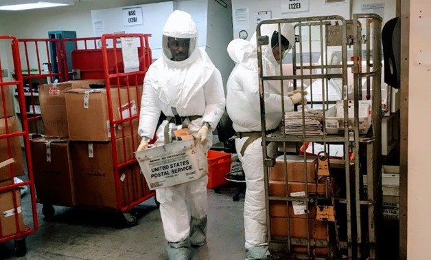 US Defense Department personnel, wearing protective suits, screen mail as it arrives at the Pentagon