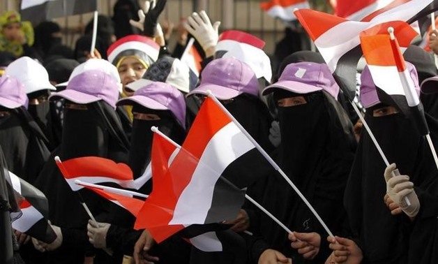 Women wave flags of Yemen during a demonstration by pro-government protesters in Sanaa August 24, 2014. REUTERS/Mohamed al-Sayaghi