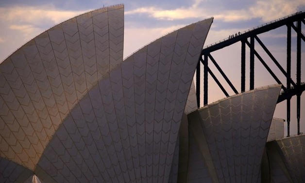 FILE PHOTO: Climbers can be seen walking up the arch of the Sydney Harbour Bridge behind the roof of the Sydney Opera House on a hot summer day in Australia, October 30, 2017. REUTERS/David Gray
