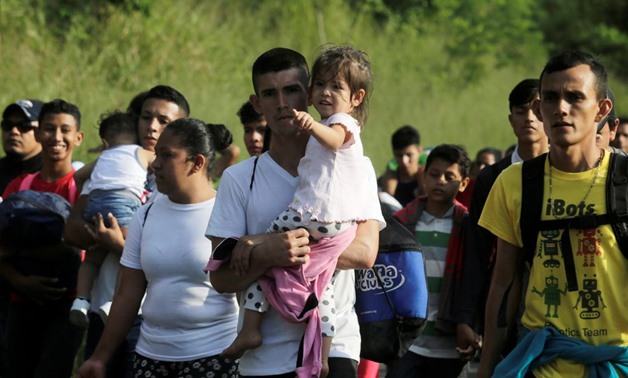 Honduran migrant group treks north as U.S. calls for tighter borders - Reuters