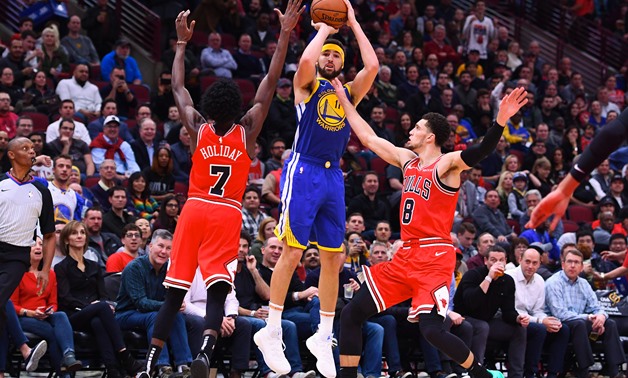 Oct 29, 2018; Chicago, IL, USA; Golden State Warriors guard Klay Thompson (11) shoots the ball against Chicago Bulls forward Justin Holiday (7) and guard Zach LaVine (8) during the second half at the United Center. Mandatory Credit: Mike DiNovo-USA TODAY 