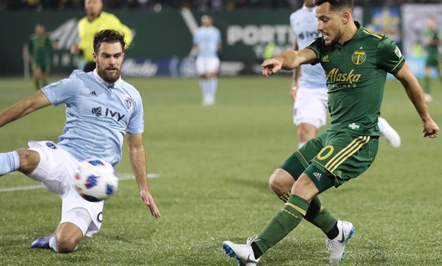 Nov 25, 2018; Portland, OR, USA; Portland Timbers midfielder Sebastian Blanco (10) kicks the ball against Sporting Kansas City midfielder Graham Zusi (8) in the second of the first leg of the MLS Western Conference Championship at Providence Park. Mandato