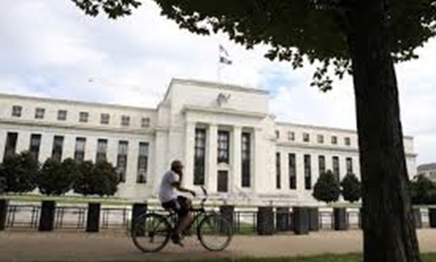 FILE PHOTO: A cyclist passes the Federal Reserve building in Washington, DC, U.S., August 22, 2018. REUTERS/Chris Wattie/File Photo/File Photo
