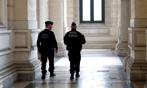 Belgian police officers patrol is seen during a preliminary hearing of Mehdi Nemmouche and Nacer Bendrer, who are suspected of killing four people in a shooting at Brussels' Jewish Museum in 2014, at Brussels Palace of Justice, Belgium December 20, 2018. 