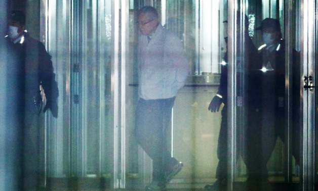 Greg Kelly (C) walked out of the Tokyo Detention Centre more than a month after his arrest and got into a waiting taxi without speaking to the media
