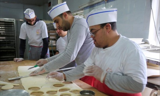 Ali Kerdi, 35, trains special needs students at a bakery in the southern city of Tyre, Lebanon December 18, 2018. Picture taken December 18, 2018. REUTERS/Ali Hashisho
