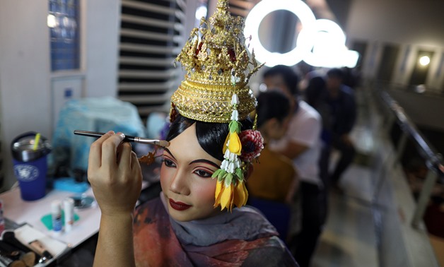 Dancers get ready backstage before a performance of masked theatre known as Khon which was recently listed by UNESCO, the United Nations' cultural agency, as an intangible cultural heritage, along with neighbouring Cambodia's version of the dance, known a