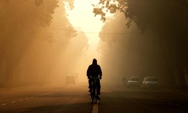 FILE PHOTO: A man rides his bicycle on a smoggy morning in New Delhi, India, December 26, 2018. REUTERS/Adnan Abidi
