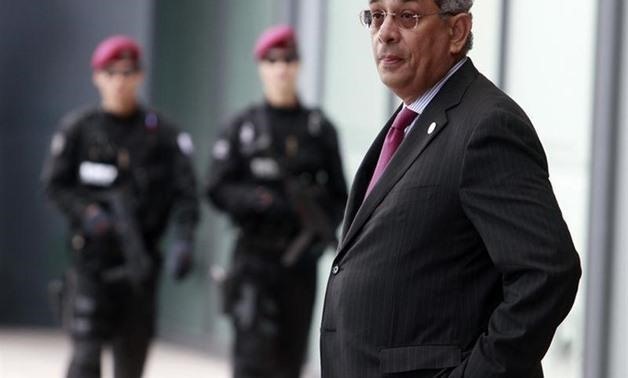 Youssef Boutros-Ghali stands in front of security officers at the venue of the G20 Finance Ministers and Central Bank Governors meeting in Gyeongju - Reuters