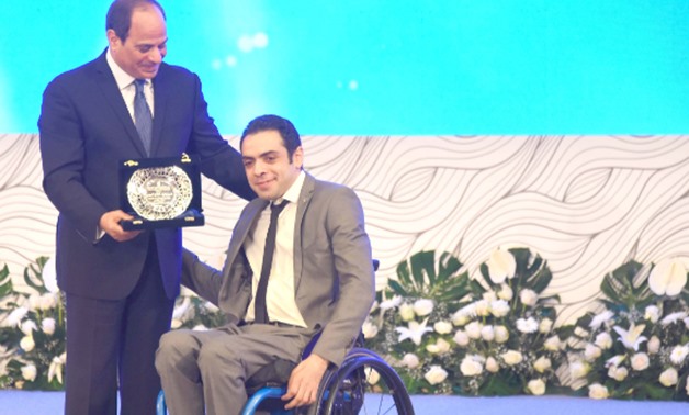 FILE - President Sisi honors a disabled person, July, 30, 2018 – Courtesy of the presidency