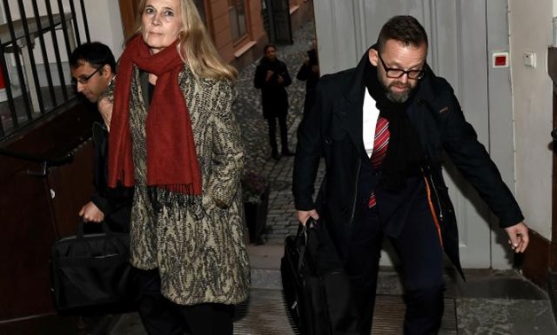 The member of the Swedish Academy and wife of Frenchman Jean-Claude Arnault, Katarina Frostenson (C), arrives to the Svea Hovratt appeal court together with laywer Bjorn Hurtig (R) and counsel Samuel Hartman (L) on the third day of Arnault's appeal trial 
