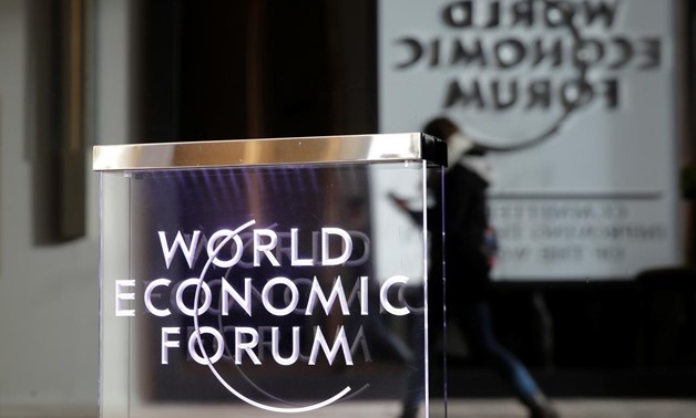 A person passes by a World Economic Forum logo in Davos, Switzerland, January 20, 2019. REUTERS/Arnd Wiegmann

