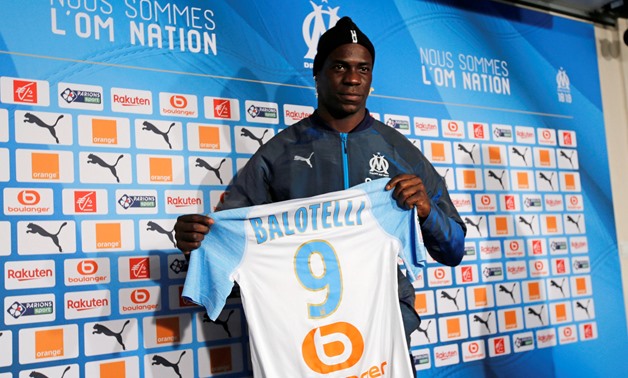 Olympique Marseille's newly-signed player Mario Balotelli poses with his jersey as he attends a news conference in Marseille, France, January 23, 2019. REUTERS/Jean-Paul Pelissier
