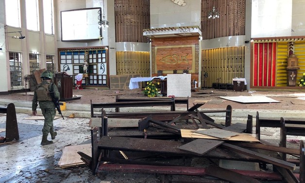 A Philippine Army member walks inside a church after a bombing attack in Jolo, Sulu province, Philippines January 27, 2019. Armed Forces of the Philippines - Western Mindanao Command/Handout via REUTERS
