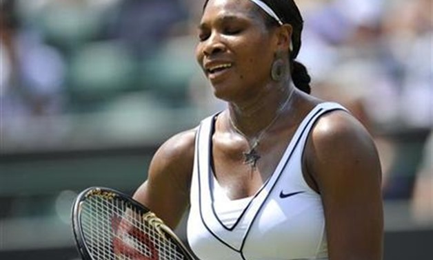 Serena Williams reacts during her match against Marion Bartoli of France at the Wimbledon tennis championships in London June 27, 2011. REUTERS/Toby Melville