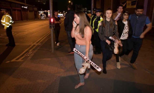 Concert goers react after fleeing the Manchester Arena in northern England where U.S. singer Ariana Grande had been performing in Manchester - REUTERS/Jon Super