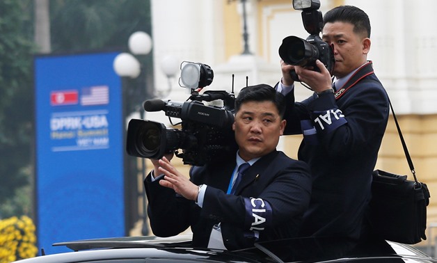 Members of North Korean media take images as motorcade of North Korea's leader Kim Jong Un rides past Opera House, after the second U.S.-North Korea summit in Hanoi, Vietnam, February 28, 2019. REUTERS/Kham
