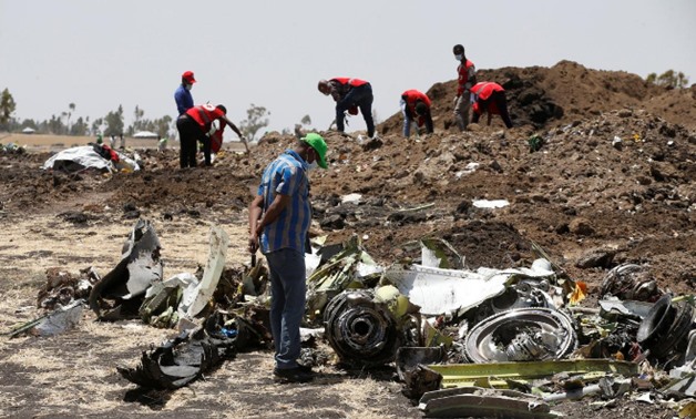 A man watches debris at the scene of the Ethiopian Airlines Flight ET 302 plane crash, near the town of Bishoftu, southeast of Addis Ababa, Ethiopia March 12, 2019. REUTERS/Baz Ratner