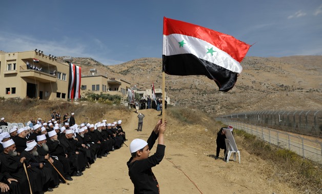 FILE PHOTO: Druze people take part in a rally in Majdal Shams near the ceasefire line between Israel and Syria in the Israeli occupied Golan Heights, overlooking the other side of the border October 6, 2018 REUTERS/Ammar Awad