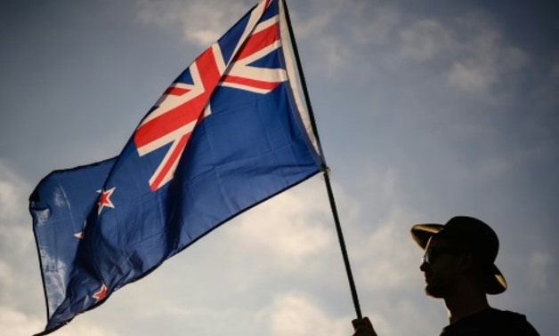 A New Zealand flag held at a vigil for the Christchurch mosque massacres. New Zealand has offered permanent residency to those directly affected by the attacks AFP/File
