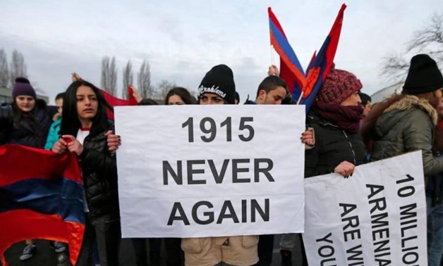 An Armenian protester holds a sign reading “1915 never again” as she takes part in a demonstration near the European Court of Human Rights in Strasbourg, on Jan 28, 2015. — Reuters