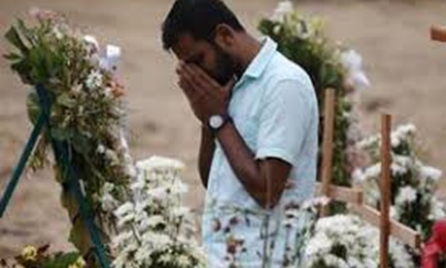 A man reacts during mass burials near St. Sebastian church in Negombo, Sri Lanka April 28, 2019. REUTERS/Athit Perawongmetha
