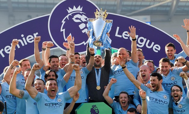 Soccer Football - Premier League - Brighton & Hove Albion v Manchester City - The American Express Community Stadium, Brighton, Britain - May 12, 2019 Manchester City manager Pep Guardiola lifts the trophy as they celebrate winning the Premier League REUT