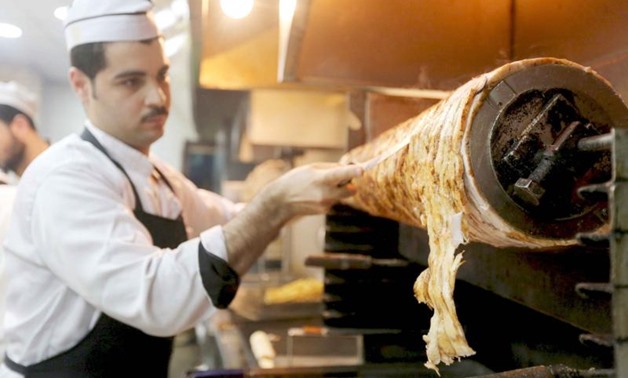 Traditional delicacies. A Syrian man work at a Syrian restaurant in 6 October City in Giza. (Reuters)