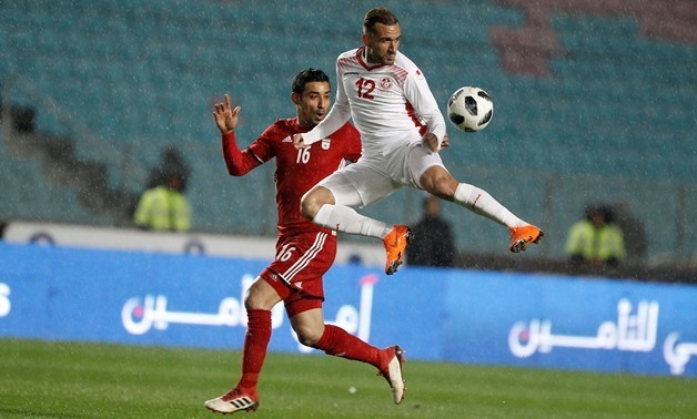 Soccer - International Friendly - Tunisia v Iran - Rades Olympic Stadium, Rades, Tunisia - March 23, 2018. Tunisia's Maaloul Ali in action with Iran's Reza Ghoochannejhad. REUTERS/Zoubeir Souissi
