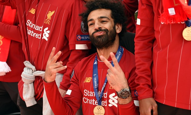 Liverpool's Egyptian midfielder Mohamed Salah gestures to the fans during an open-top bus parade around Liverpool, north-west England on June 2, 2019, after winning the UEFA Champions League final football match between Liverpool and Tottenham. Liverpool'