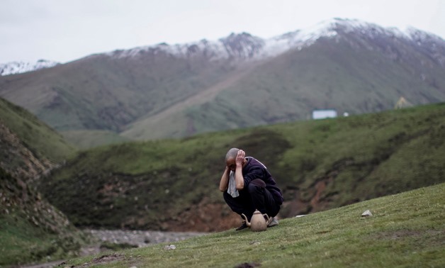 An ethnic Hui Muslim cordyceps picker cleans himself at a base camp on a mountain in the Amne Machin range in China's western Qinghai province, June 8, 2019. Cordyceps pickers are hired by a local company to find and pick the Ophiocordyceps sinensis, a fu