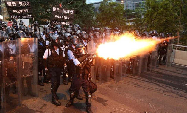 Police officers fire tear gas during a demonstration against a proposed extradition bill in Hong Kong

