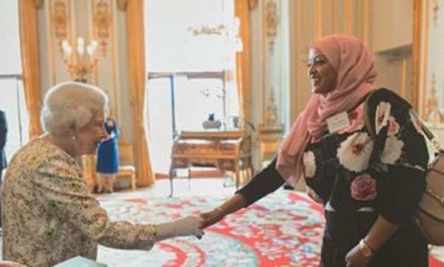 Egyptian young woman Inas Ibrahim Helal on being honored by Queen Elizabeth II for her services to the local community and doing a number of charitable works - Press Photo
