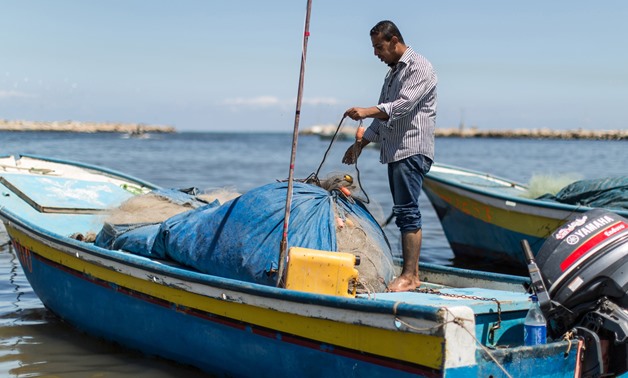 Fisherman Amjad al-Shirafi is preparing his boat at the Gaza seaport - Photo from UNRWA website