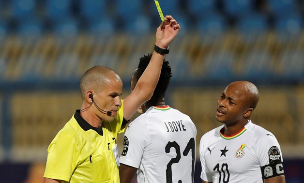 Soccer Football - Africa Cup of Nations 2019 - Round of 16 - Ghana v Tunisia - Ismailia Stadium, Ismailia, Egypt - July 8, 2019 Ghana's John Boye is shown a yellow card by referee Victor Gomes REUTERS/Amr Abdallah Dalsh

