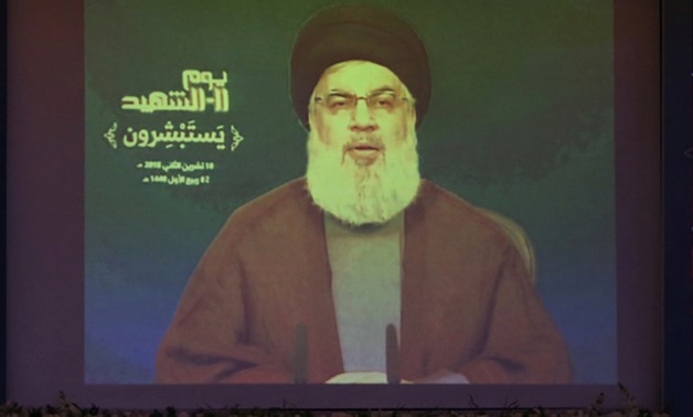 FILE PHOTO: Lebanon's Hezbollah leader Sayyed Hassan Nasrallah addresses his supporters via a screen in Nabatiyeh, Lebanon, November 10, 2018. REUTERS/Aziz Taher/File Photo