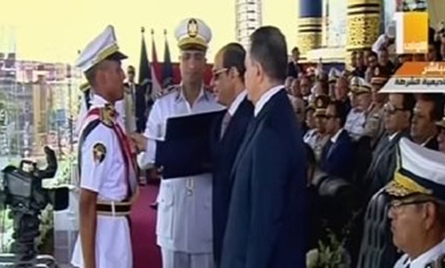 President Abdel Fatah al-Sisi awards an honor student a second-class Order of Excellence in the 2019 Police Academy Commencement. July 20, 2019. TV screenshot