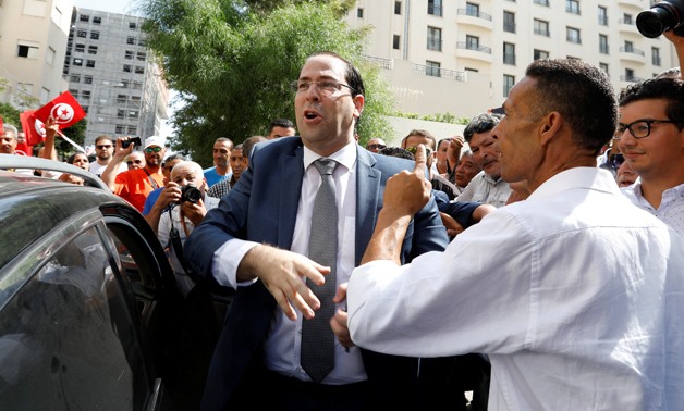 Tunisian Prime Minister Youssef Chahed reacts surrounded by supporters after submitting his candidacy for the presidential elections in Tunis, Tunisia August 9, 2019. REUTERS/Zoubeir Souissi
