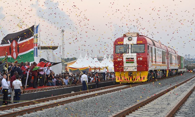 People cheer and throw confetti at a cargo train in Mombasa on May 30, 2017 – AFP/TONY KARUMBA