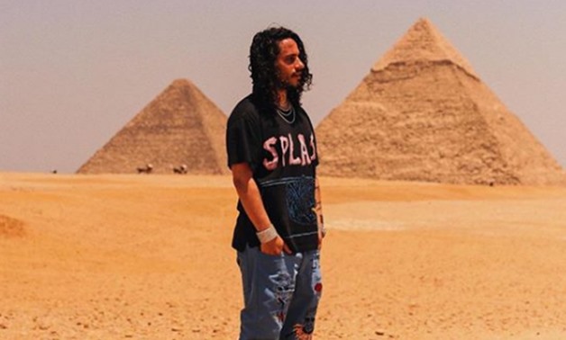FILE - American rapper Russell Vitale in front of Giza Pyramids - Instagram account
