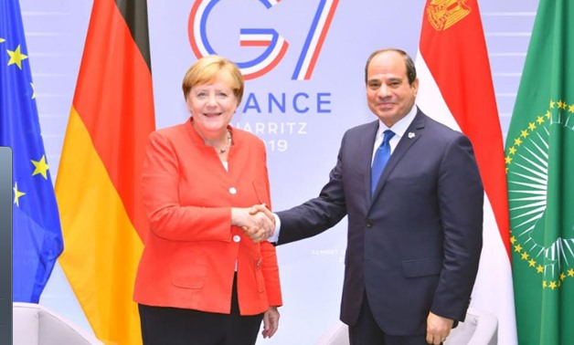President Abdel Fatah al-Sisi during his meeting with German Chancellor Angela Merkel on August 25 on the sidelines of the G7 summit held in Biarritz, France - Press Photo
