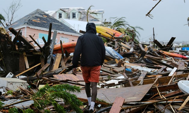 FILE PHOTO: A man walks through the rubble in the aftermath of Hurricane Dorian on the Great Abaco island town of Marsh Harbour, Bahamas, September 2, 2019. REUTERS/Dante Carrer/File Photo
