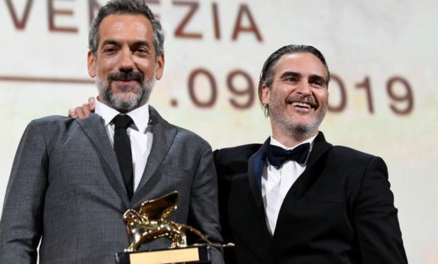 The 76th Venice Film Festival - Awards Ceremony - Venice, Italy, September 7, 2019 - Director Todd Phillips poses next to Joaquin Phoenix after winning the Golden Lion for Best Film. REUTERS/Piroschka van de Wouw.